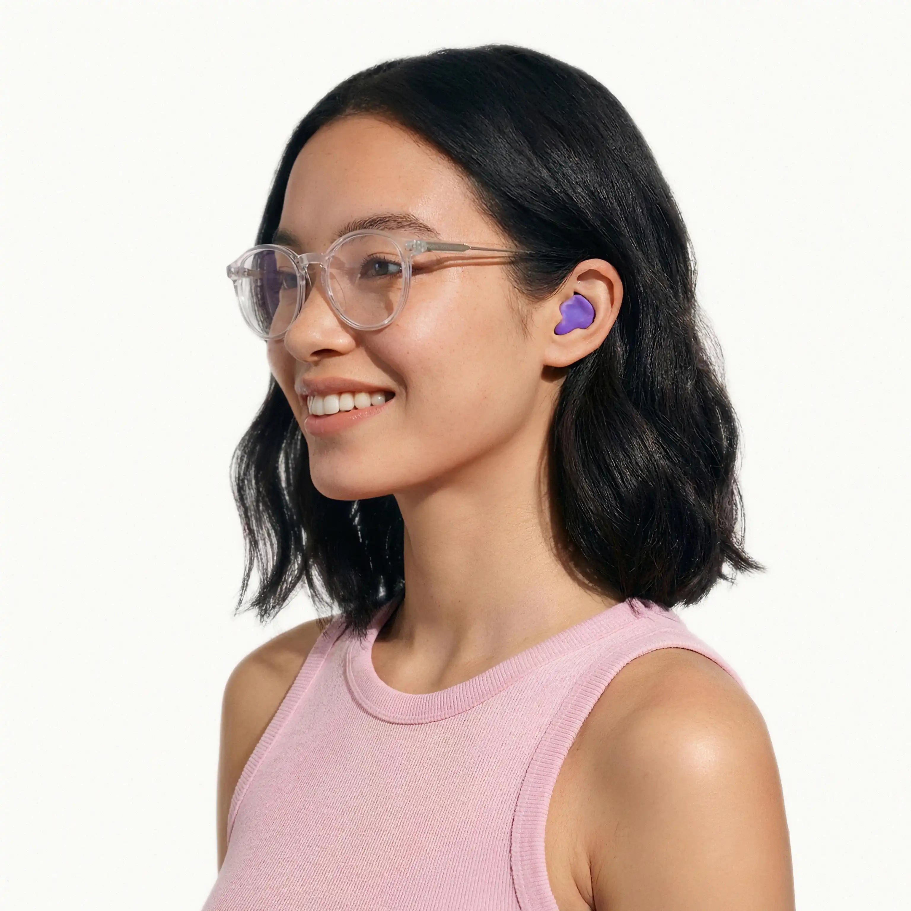 Purple mouldable earplug for noise cancelling and sleep comfort, demonstrated by a woman wearing the product for a secure and low-profile fit