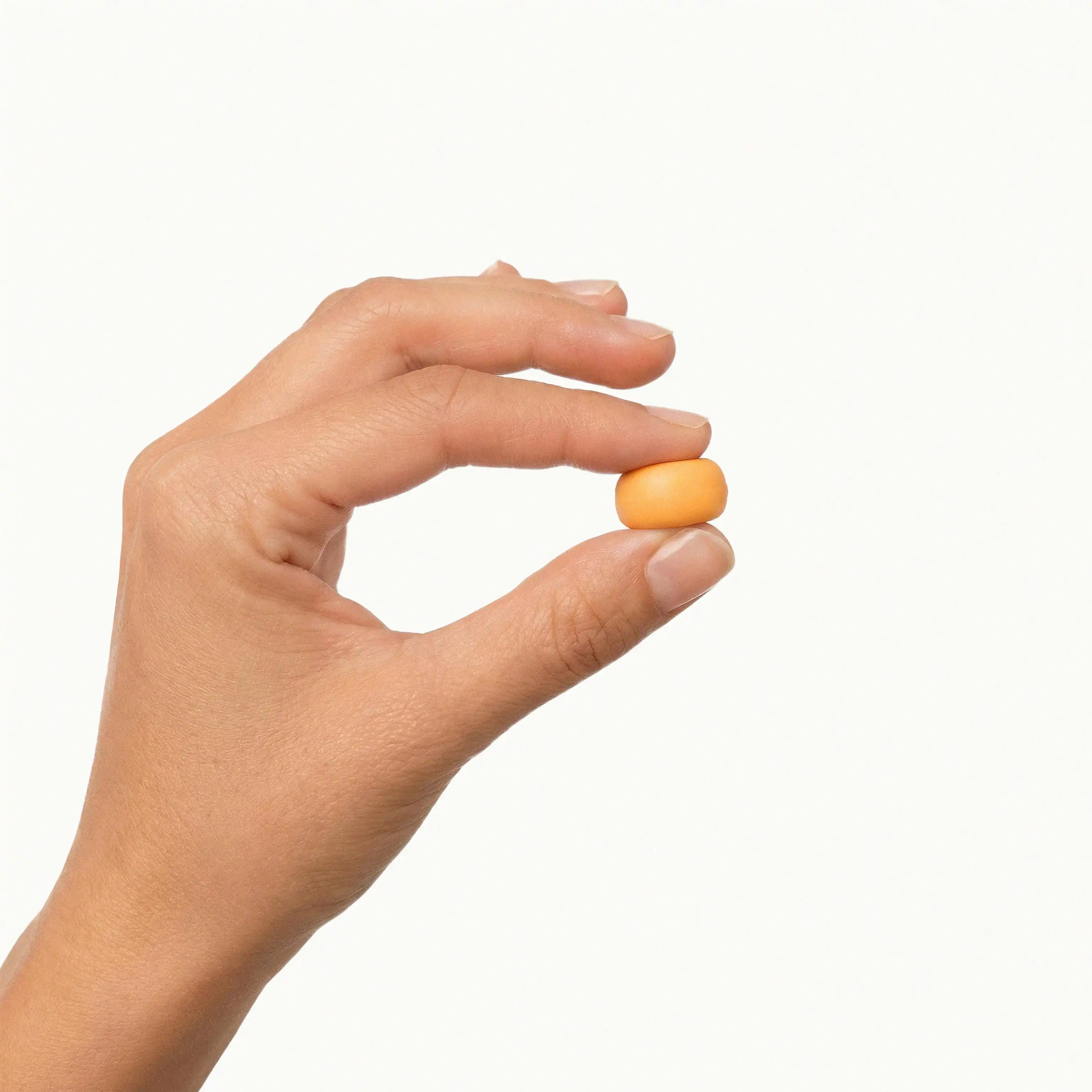 Two fingers pinching a small orange mouldable earplug to demonstrate the soft and pliable silicone texture