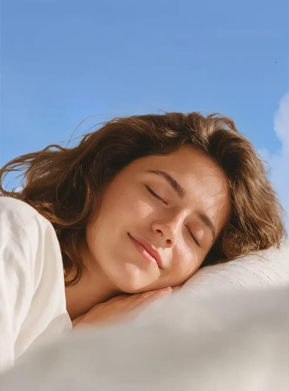 A woman sleeping peacefully on a pillow, experiencing quiet rest with Soundbuds earplugs.